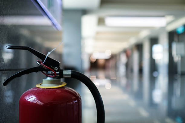 istock Close up on fire extinguisher in a modern building. The subject is on the left. 1263876602