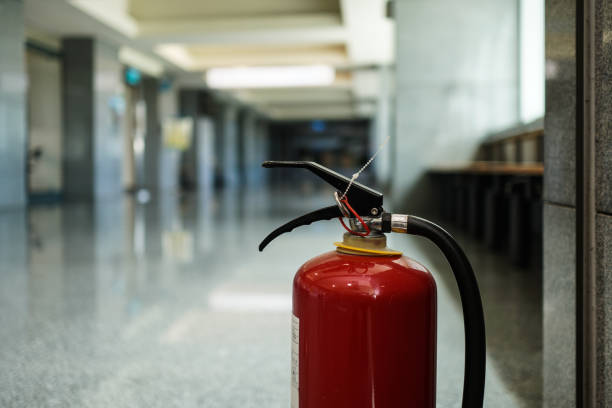 istock Close up on fire extinguisher in a modern building. The subject is on the right. 1263876714
