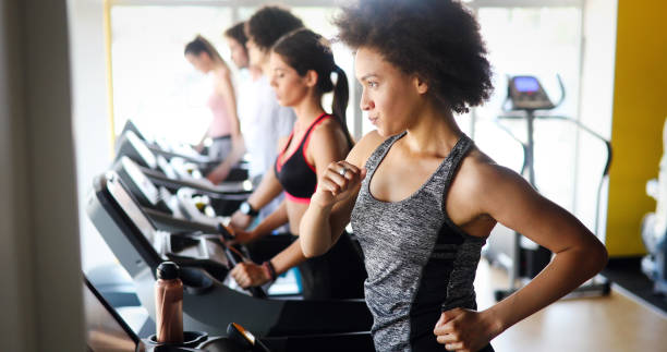 istock Group of young people exercising on a treadmill at gym 1263876783