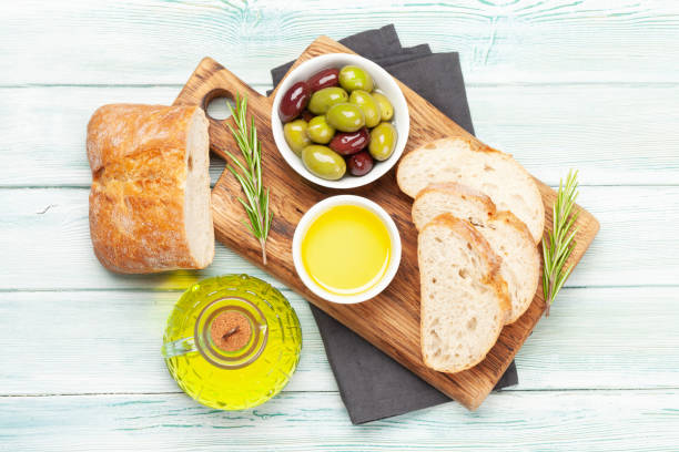 istock Ripe olives, olive oil and ciabatta bread 1263880482