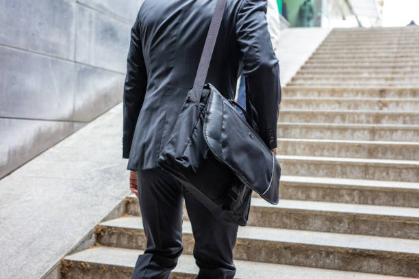 istock Businessman walking up stairs 1263880933