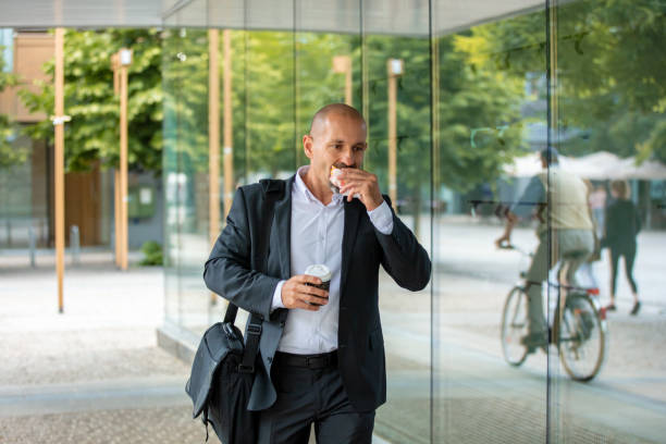istock Businessman eating his lunch in rush 1263880993