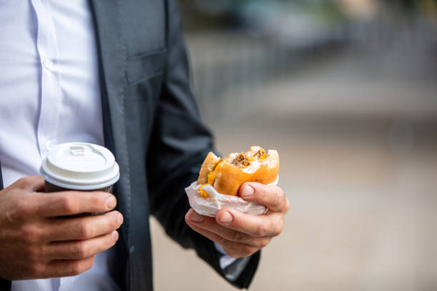 istock Man hands holding burger and coffee 1263881007
