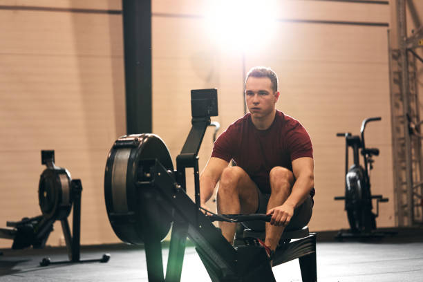 istock Young man working out on a gym rowing machine 1263881811