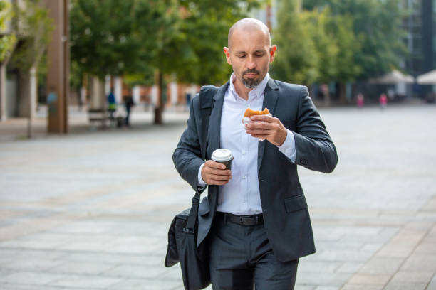 istock Man eating his lunch in rush 1263881874