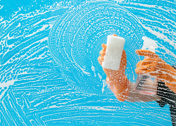 istock Cleaning glass window with sponge and spray bottle 1263884049