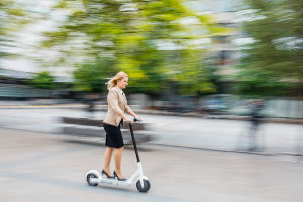 istock Woman riding on electric push scooter 1263884385