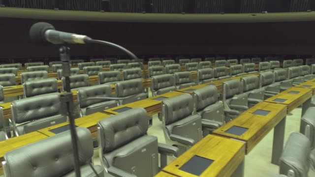 Stablised tracking shot across the chairs in the Lower House, the Chamber of Deputies in the Brazilian Congress, Brasilia