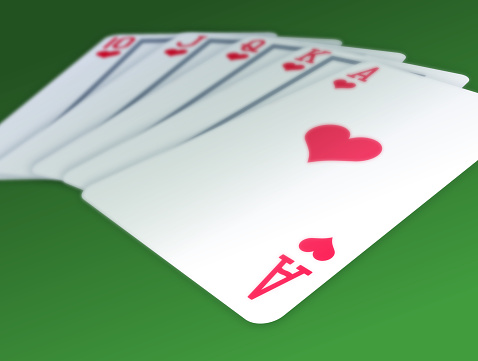 A royal flush of cards with depth of field view.