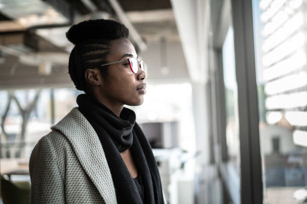 istock Serious businesswoman looking through the window 1263887609