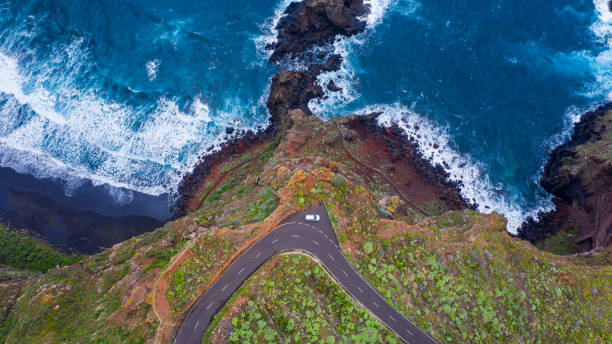 View of road winding along rocky coastline, La Palma, Canary Islands, Spain View of winding road by sea la palma canary islands photos stock pictures, royalty-free photos & images