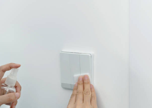 istock Woman hand wiping the light switch 1263891335