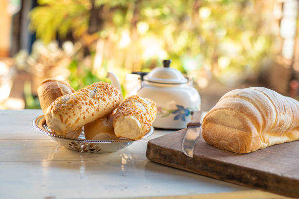 Cafe table with breads, crackers and accessories with blurred background, natural light on white table, selective focus