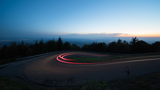 light trails at evening from cars in a curve in germany.