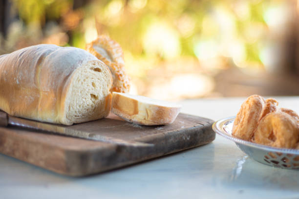 Cafe table with homemade bread with blurred background, natural light on white table, selective focus