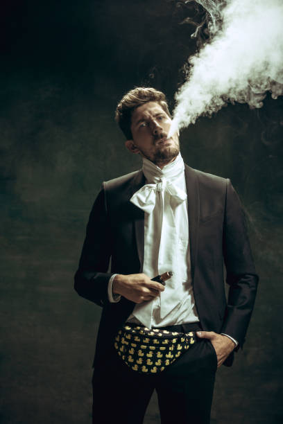 istock Young man as Dorian Gray on dark background. Retro style, comparison of eras concept. 1263891803