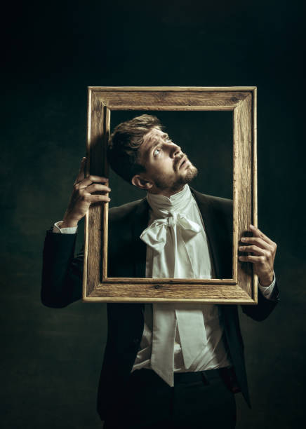 istock Young man as Dorian Gray on dark background. Retro style, comparison of eras concept. 1263891822