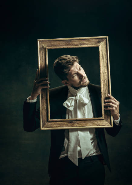 istock Young man as Dorian Gray on dark background. Retro style, comparison of eras concept. 1263891823