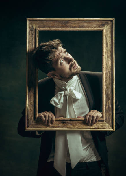 istock Young man as Dorian Gray on dark background. Retro style, comparison of eras concept. 1263891827