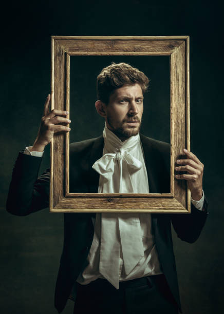 istock Young man as Dorian Gray on dark background. Retro style, comparison of eras concept. 1263891830