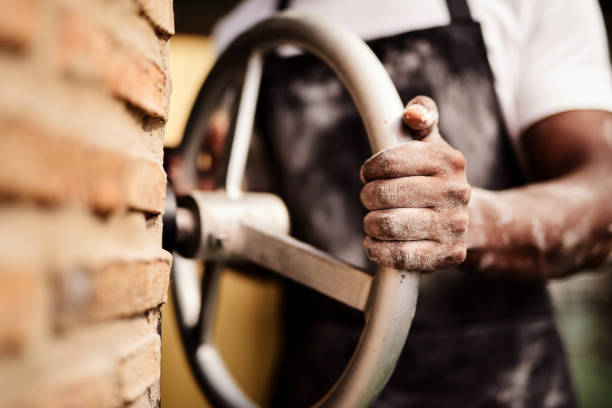 Cropped shot of a male baker working in his bakery