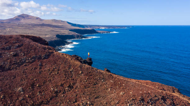 istock Man watching seascape from cliff top, Lanzarote, Canary Islands, Spain 1263893175
