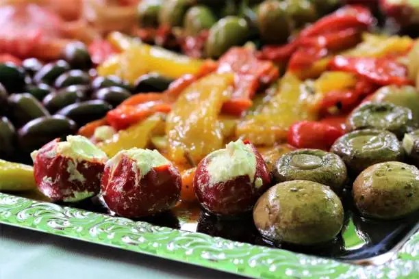 Close up of a various of antipasti on a silvercolored tray