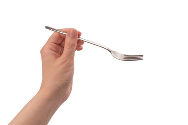 istock Fork in woman hand isolated on white. 1263894648