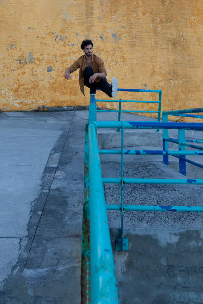 istock Man standing in one foot on the railing 1263895693