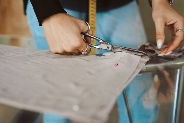 istock Tailor woman hands working on fabric 1263895937