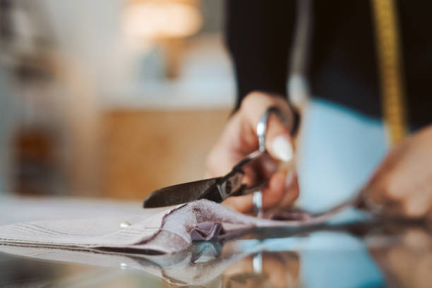 istock Tailor woman hands working on fabric 1263895938