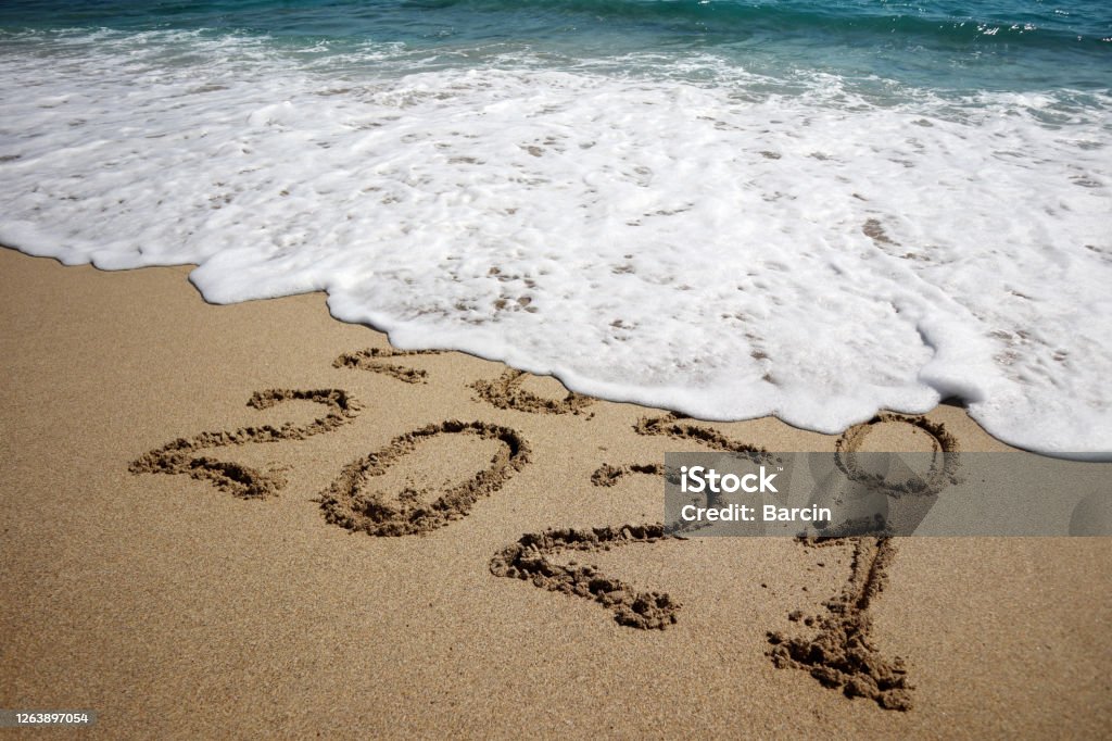 New year 2021 New year 2021 and old year 2020 written on sandy beach with waves 2021 Stock Photo