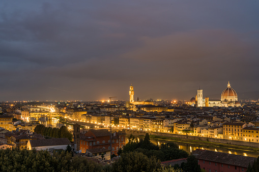 Florence old city skyline at night with Ponte Vecchio over Arno River and Cathedral of Santa Maria del Fiore in Florence, Tuscany, Italy