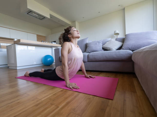 istock Woman doing yoga exercises at home during the quarantine 1263897853