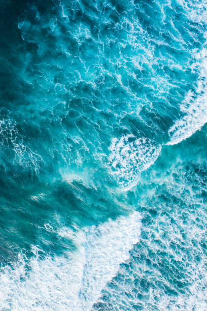 istock Big ocean waves hitting a coral reef. View from above. 1263899381