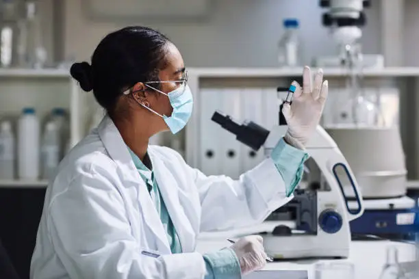 Cropped shot of an attractive young female scientist examining a medical sample inside of a vile while working in her laboratory