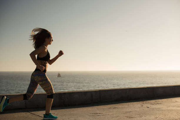 istock Fit woman doing exercises on summer sunset 1263900726