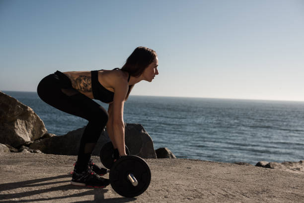 istock Fit woman lifting weights - Outdoor 1263900749