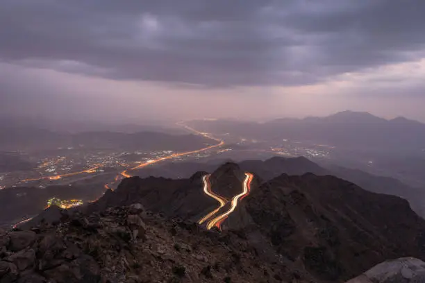 Photo of Traffic light trails wrapped around mountain on the zig zag road in Al Hada, Taif region of Saudi Arabia