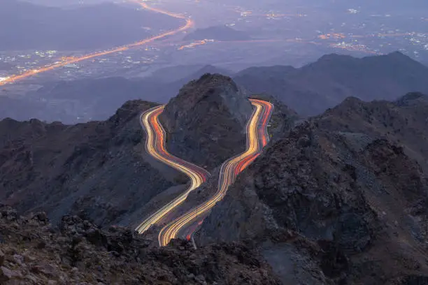 Photo of Traffic light trails wrapped around mountain on the zig zag road in Al Hada, Taif region of Saudi Arabia