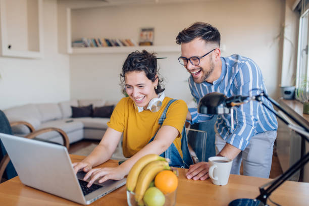 istock Young couple enjoying working from home together 1263901718
