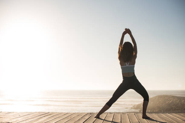 istock Women doing pilates on the beach 1263901769