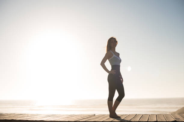 istock Fit woman enjoying sunset on the beach 1263901780
