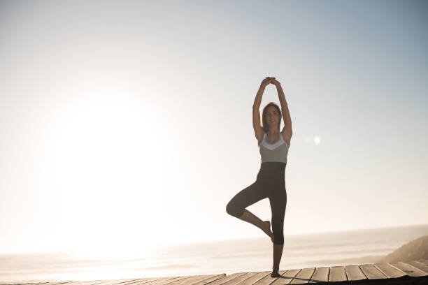 istock Fit woman enjoying sunset on the beach 1263901788