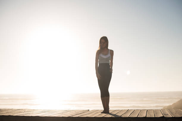 istock Fit woman enjoying sunset on the beach 1263901789