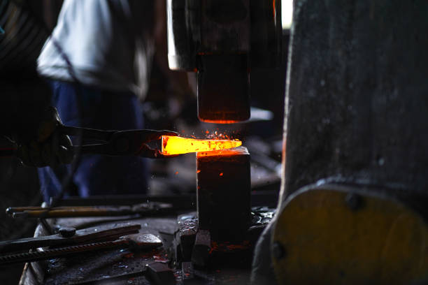 istock forging and shaping metal with machine and sparks 1263904122