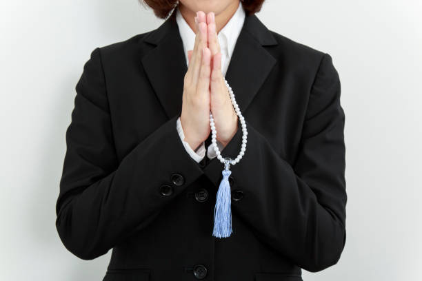 istock close up of praying hands and rosary 1263904132