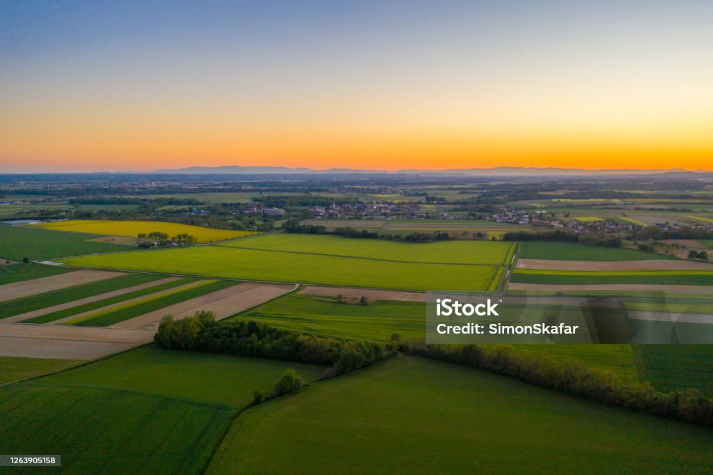 Aerial view of patchwork quilt landscape of agricultural fields at sunrise. Agricultural fields at sunrise Aerial view of patchwork quilt landscape of agricultural fields at sunrise Patchwork Landscape Stock Photo