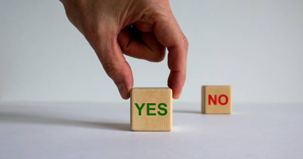 istock Hand making a choice between two cubes with 'Yes' and 'No' words on beautiful white background. Business concept. 1263905417
