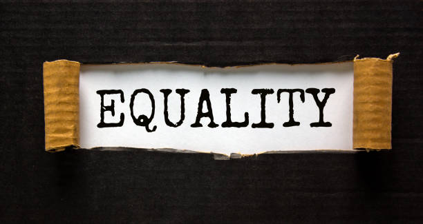 istock The word 'equality' appearing behind torn black paper. Beautiful background. Concept. 1263905436
